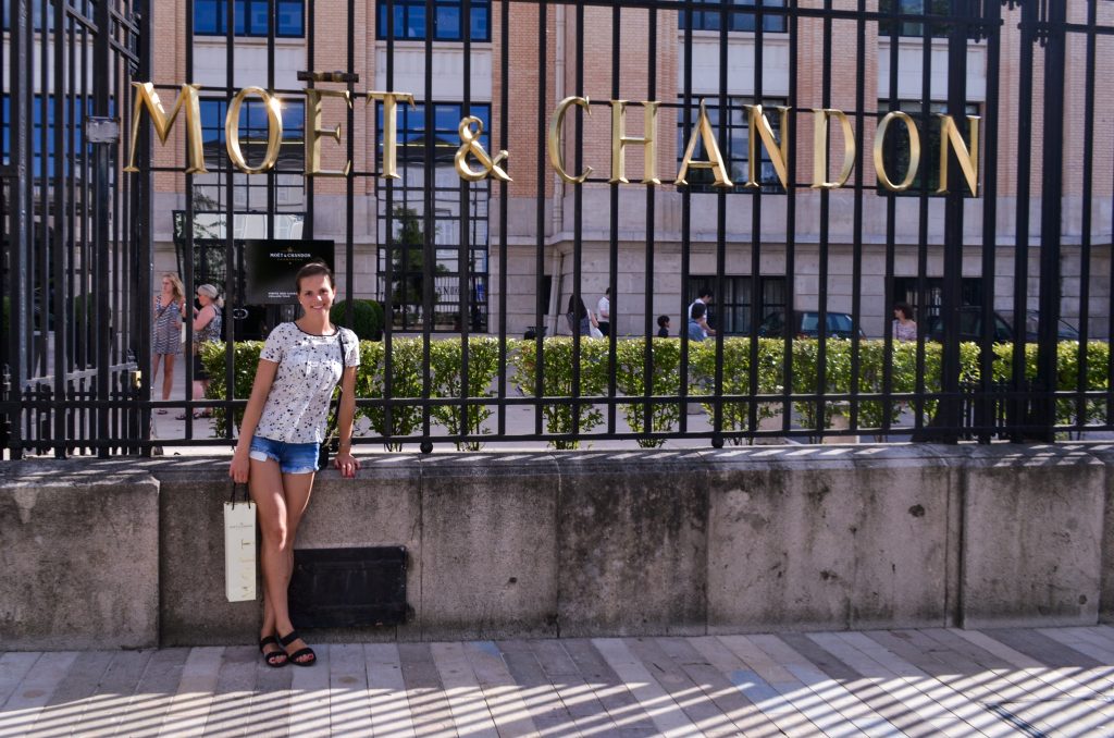 A girl standing in front of Moet & Chandon champagne house entrance