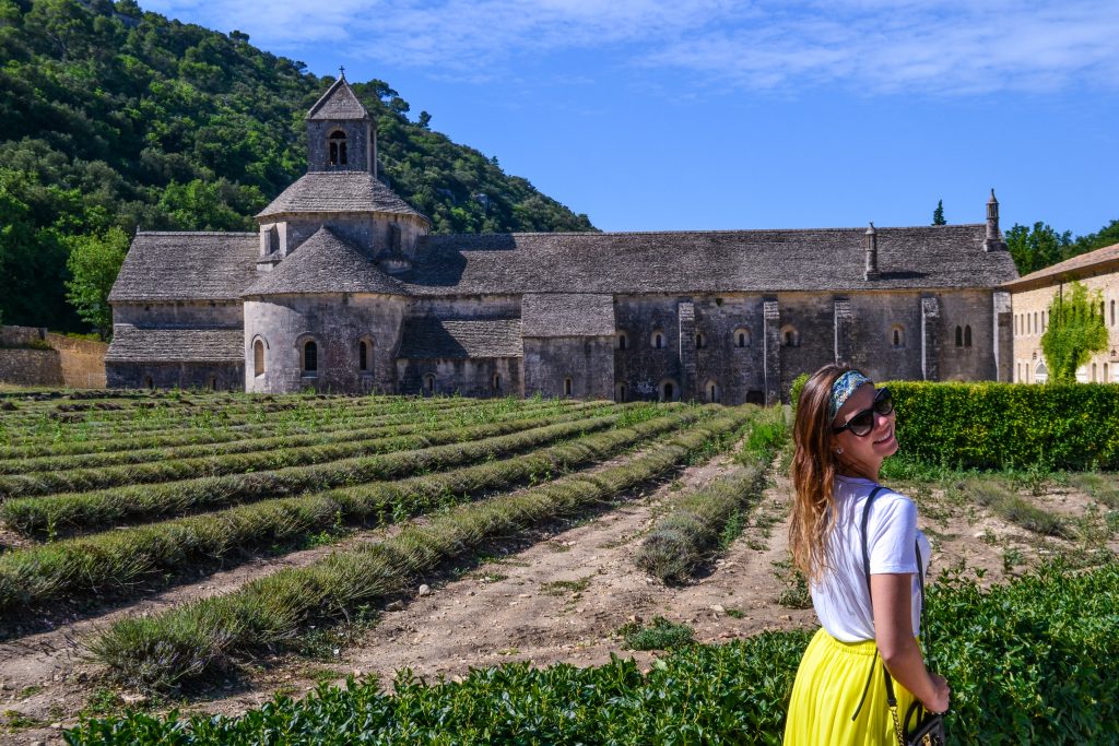 A girl in front of an abbey in Provence