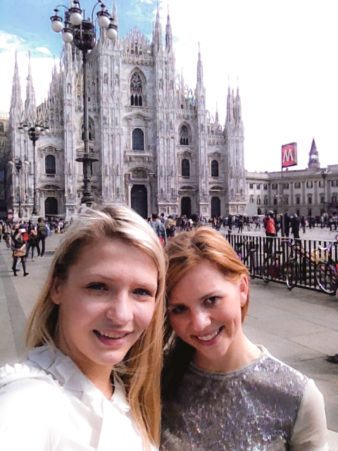 2 girls in front of Duomo Di Milano cathedral