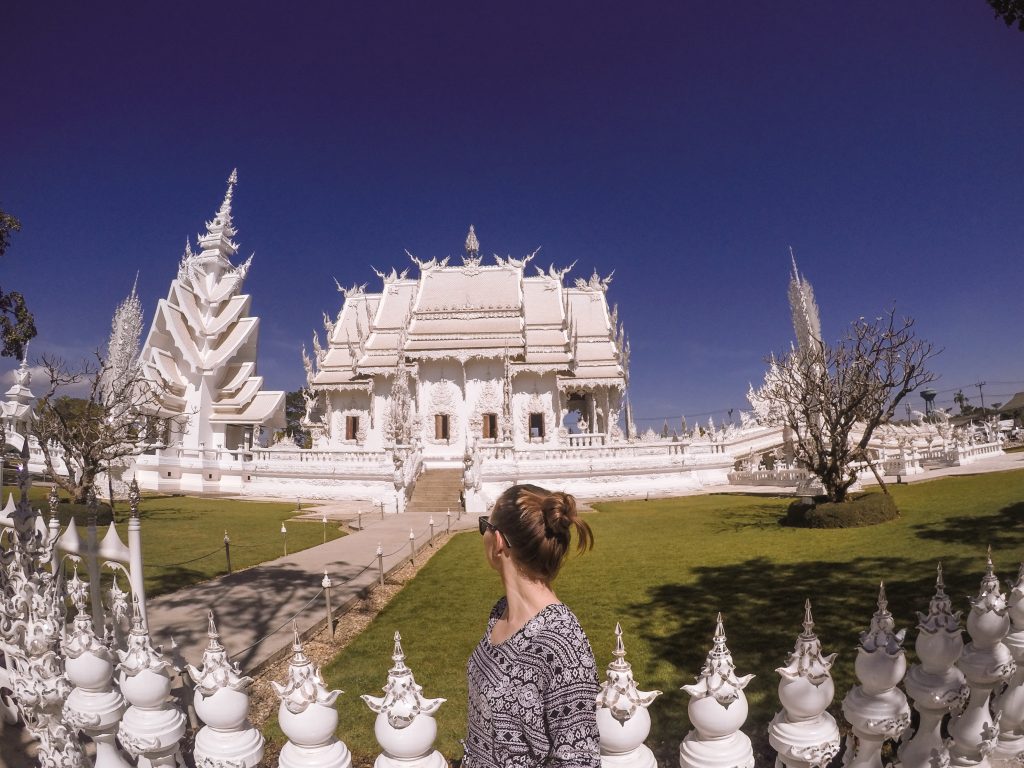 A girl standing in front of Wat Rong Khun (The White Temple), Chiang Rai