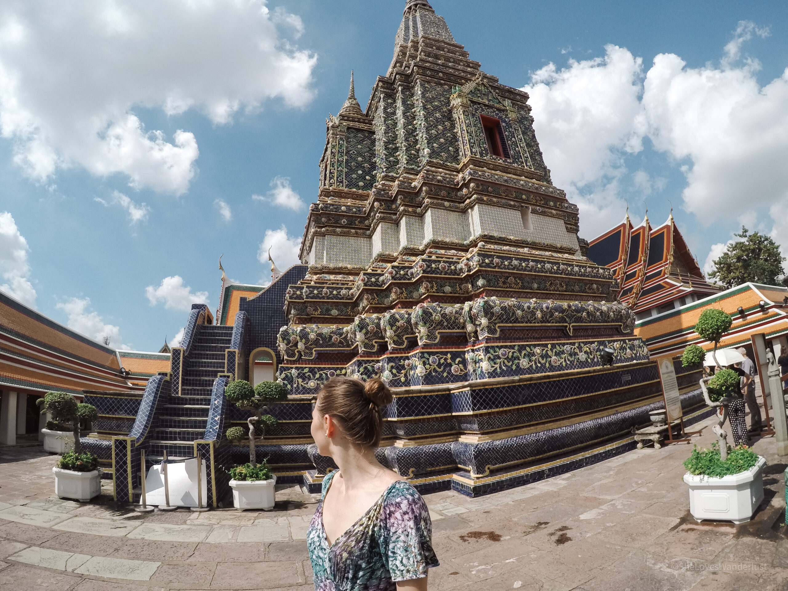 A girl standing in front of a temple in Bangkok, Thailand